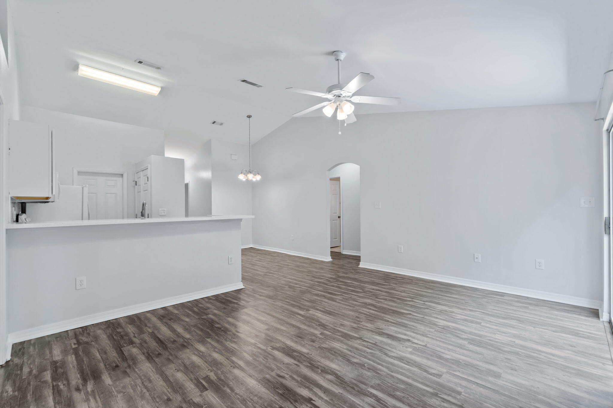 218 Cabana Way Crestview, FL 32536 - Photo 9 of 35 a view of an empty room with window and wooden floor