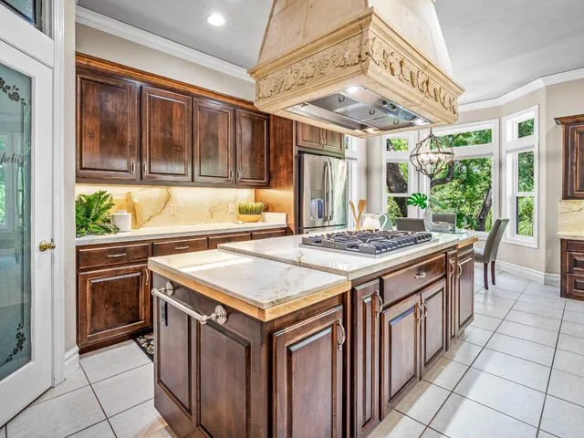 a kitchen with a stove a sink and a refrigerator