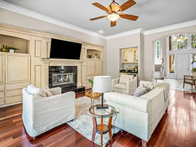 a living room with fireplace furniture and a flat screen tv