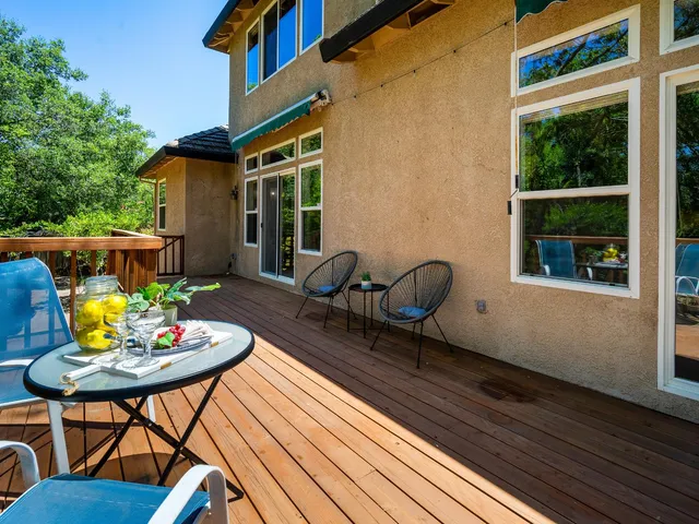 a backyard of a house with barbeque oven table and chairs