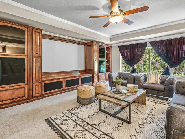 a living room with furniture a window and a chandelier
