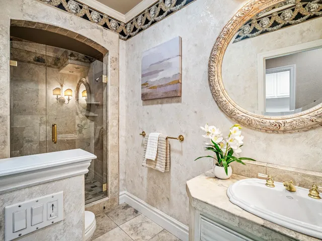 a bathroom with a sink a mirror and a shower