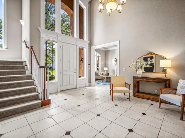 a living room with furniture and a chandelier