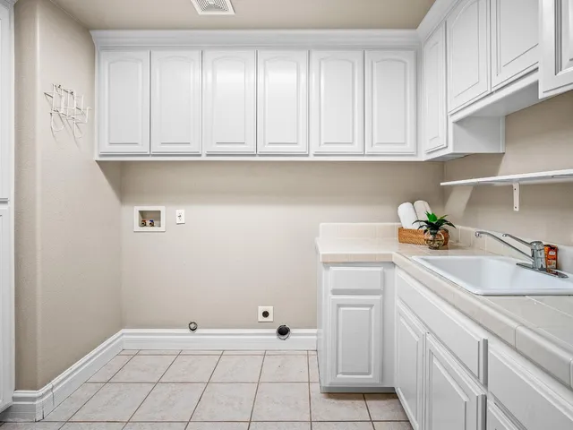 a view of cabinets with sink and dishwasher