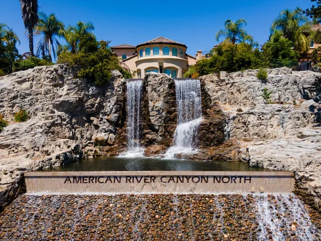 a view of a yard with wooden fence