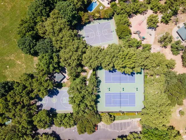 an aerial view of a house with a garden and yard