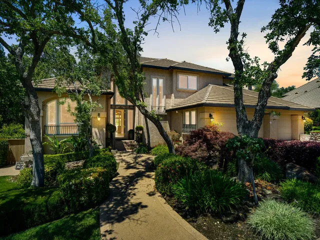 a front view of house with a garden