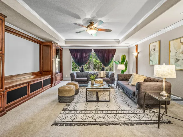 a living room with fireplace furniture and a flat screen tv
