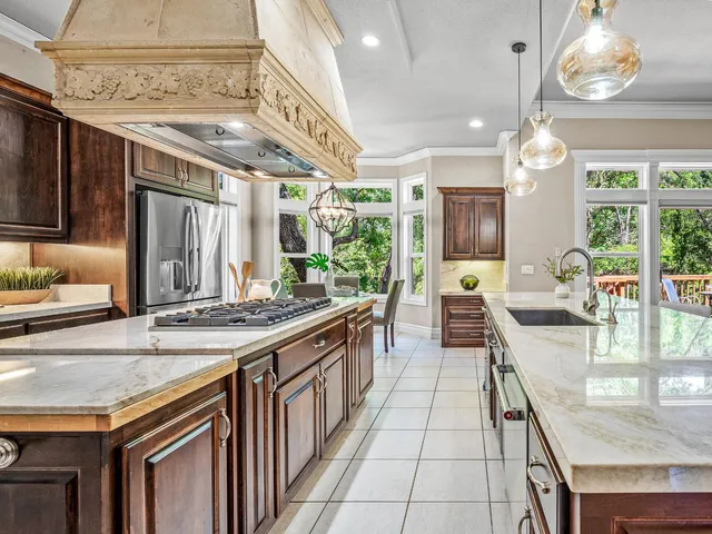 a kitchen with stainless steel appliances granite countertop a stove and a wooden cabinets