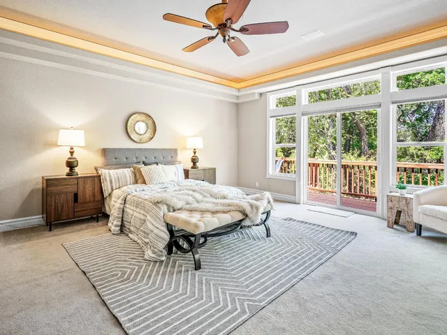 a spacious bedroom with a bed a table and a large window