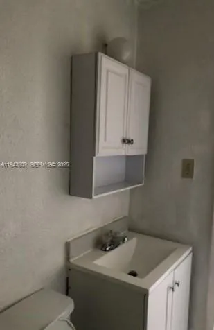 a bathroom with a sink and cabinets