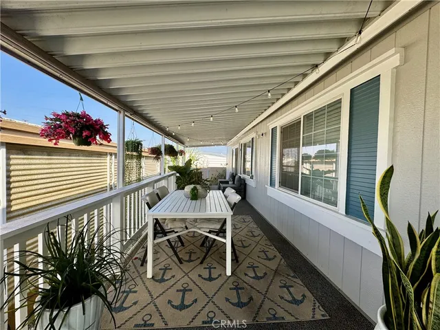 a view of a patio with table and chairs and potted plants