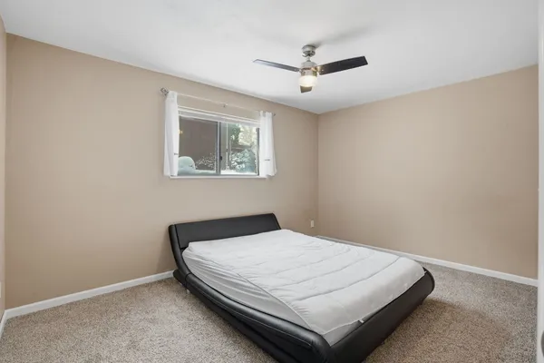 a bedroom with a bed and window