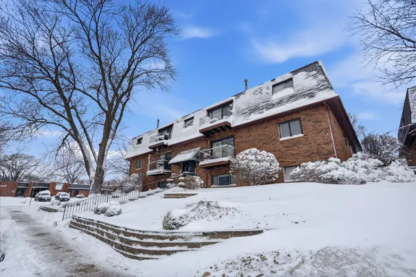 a view of a house with a snow in the yard