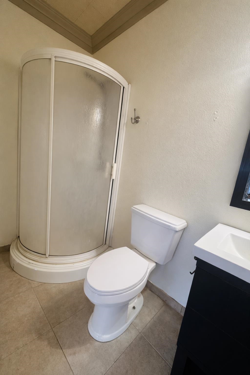206 East Sandstone Street Llano, TX 78643 - Photo 12 of 16 a white toilet sitting next to a shower