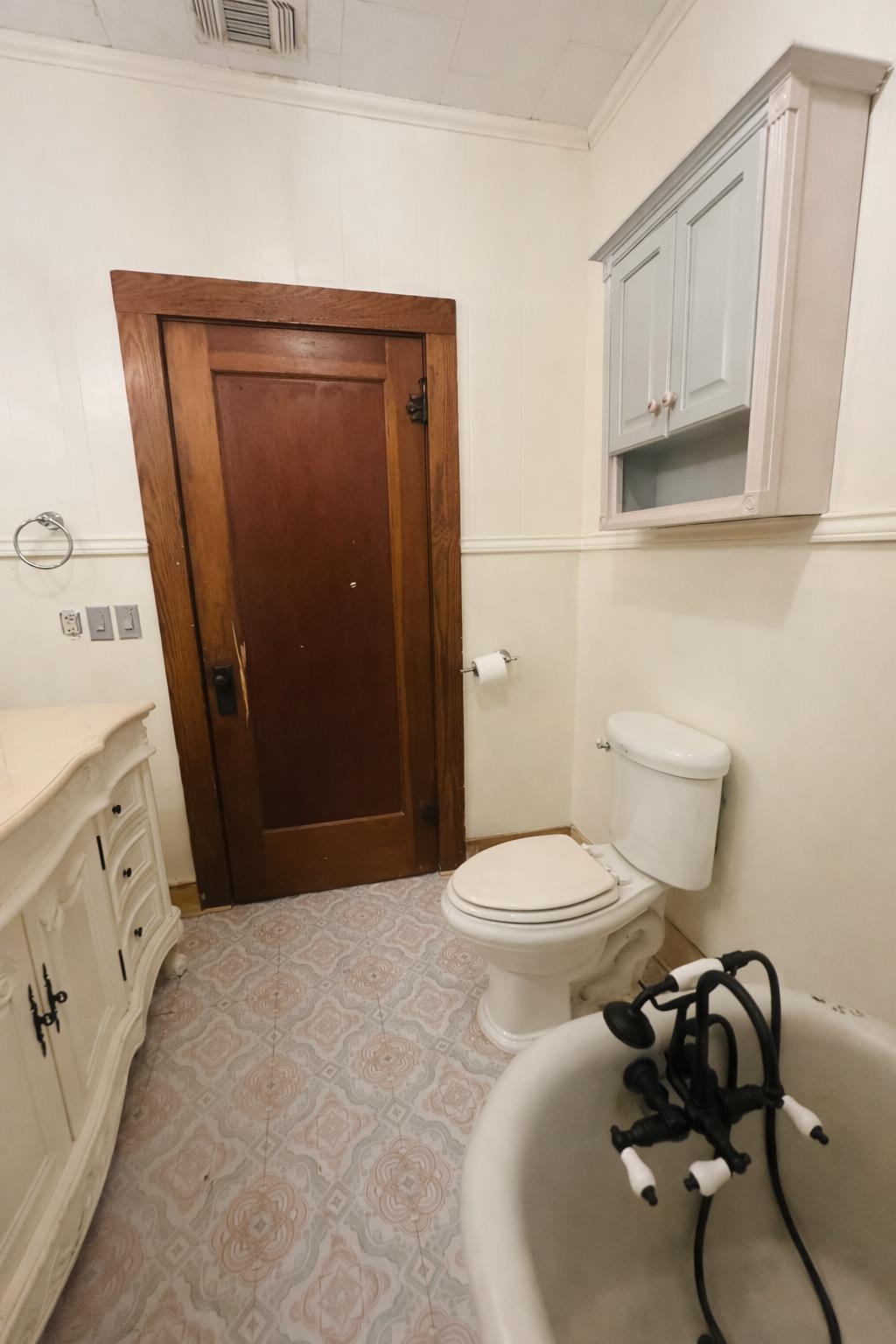 206 East Sandstone Street Llano, TX 78643 - Photo 14 of 16 a bathroom with a toilet sink and mirror