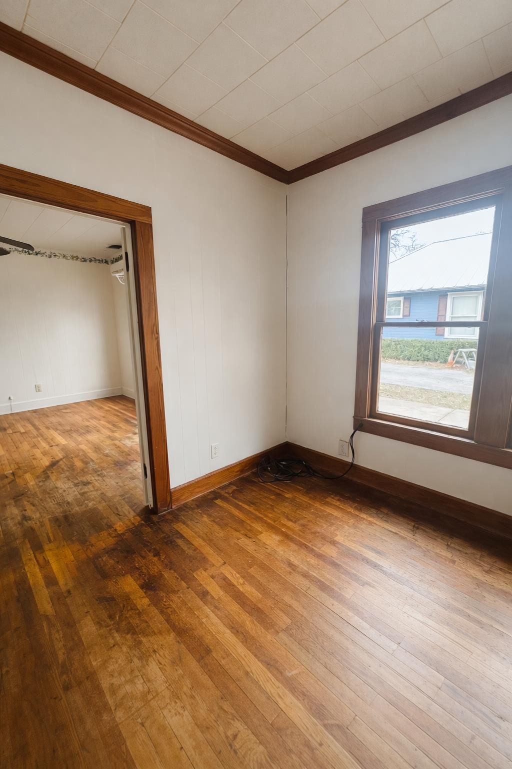 206 East Sandstone Street Llano, TX 78643 - Photo 7 of 16 a view of an empty room with wooden floor and a window