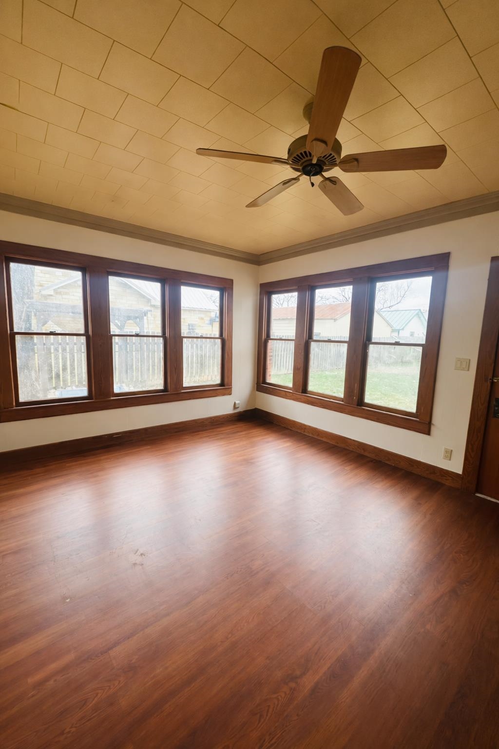 206 East Sandstone Street Llano, TX 78643 - Photo 8 of 16 an empty room with wooden floor and windows