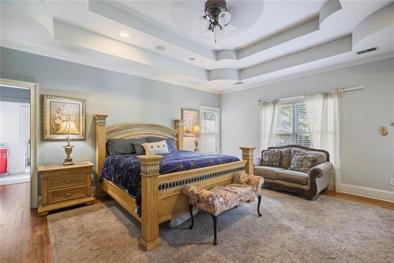 1665 Cunningham Road Southwest Marietta, GA 30008 - Photo 12 of 36 a spacious bedroom with a bed a couch and dresser