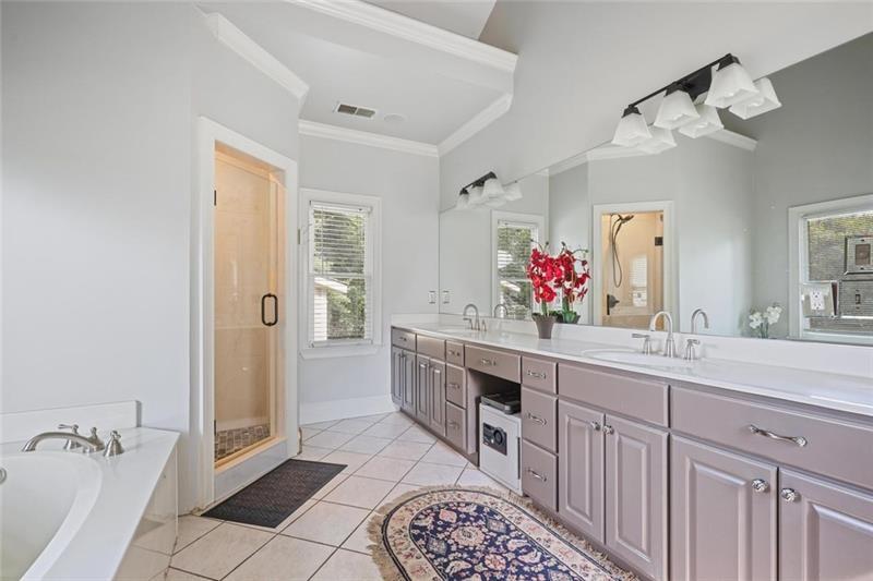 1665 Cunningham Road Southwest Marietta, GA 30008 - Photo 13 of 36 a spacious bathroom with a double vanity sink mirror and shower