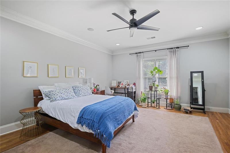 1665 Cunningham Road Southwest Marietta, GA 30008 - Photo 14 of 36 a bedroom with a large bed and a large window