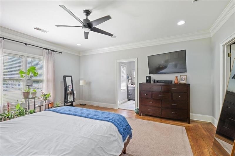 1665 Cunningham Road Southwest Marietta, GA 30008 - Photo 15 of 36 a bedroom with a bed and a flat tv screen on dresser