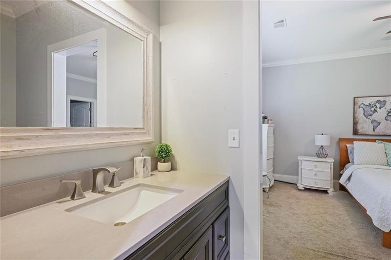 1665 Cunningham Road Southwest Marietta, GA 30008 - Photo 18 of 36 a en suite bathroom with a sink and a mirror