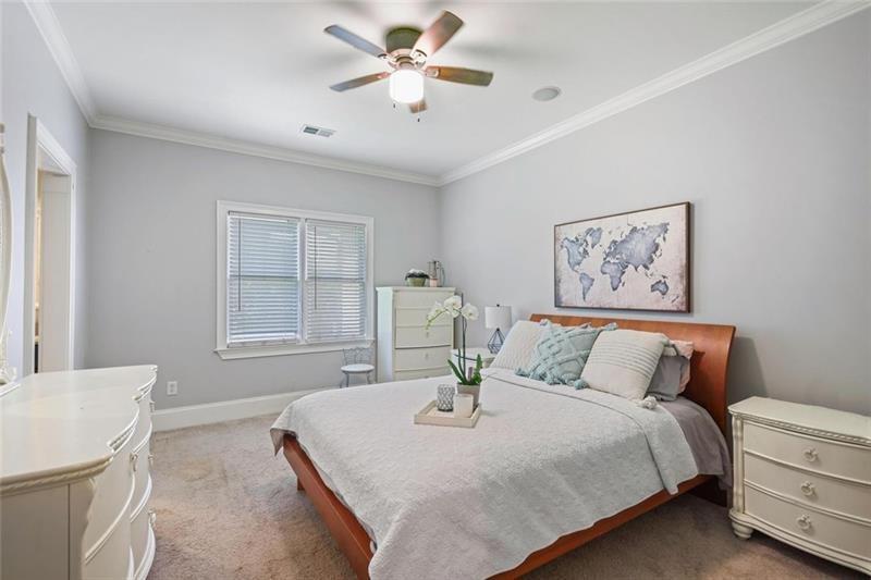 1665 Cunningham Road Southwest Marietta, GA 30008 - Photo 19 of 36 a bedroom with a bed and a chandelier