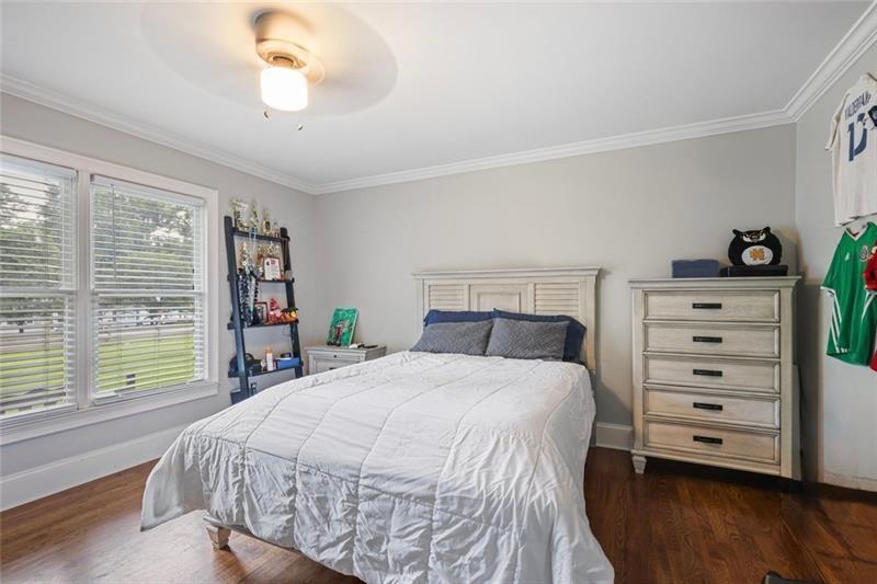 1665 Cunningham Road Southwest Marietta, GA 30008 - Photo 20 of 36 a bed sitting in a bedroom next to a window