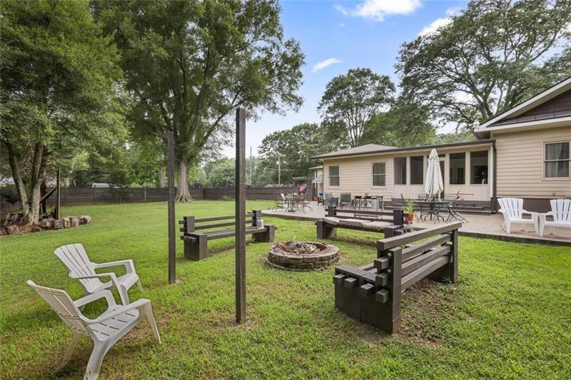 1665 Cunningham Road Southwest Marietta, GA 30008 - Photo 22 of 36 a view of a house with backyard sitting area and garden