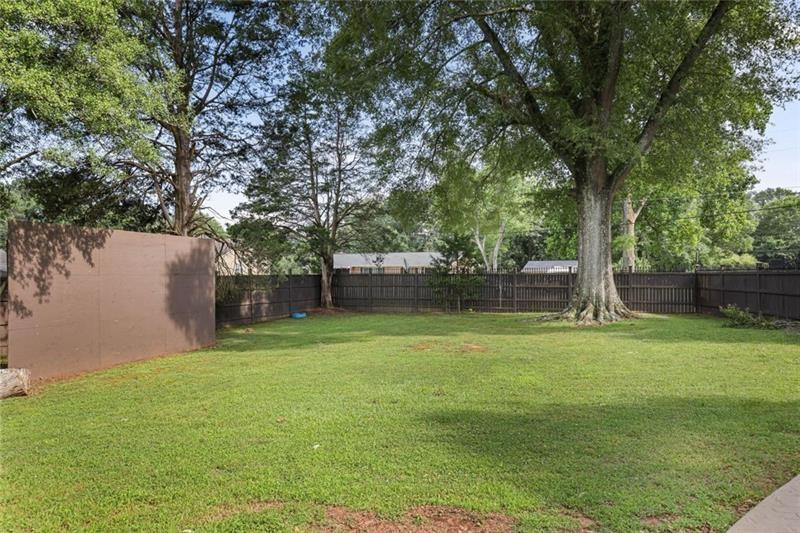 1665 Cunningham Road Southwest Marietta, GA 30008 - Photo 24 of 36 a backyard of a house with lots of green space