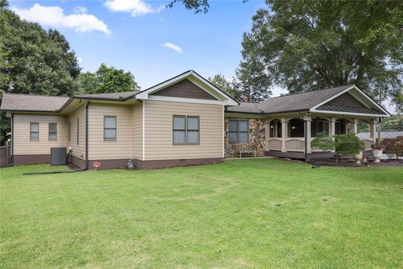 1665 Cunningham Road Southwest Marietta, GA 30008 - Photo 28 of 36 a front view of a house with a garden