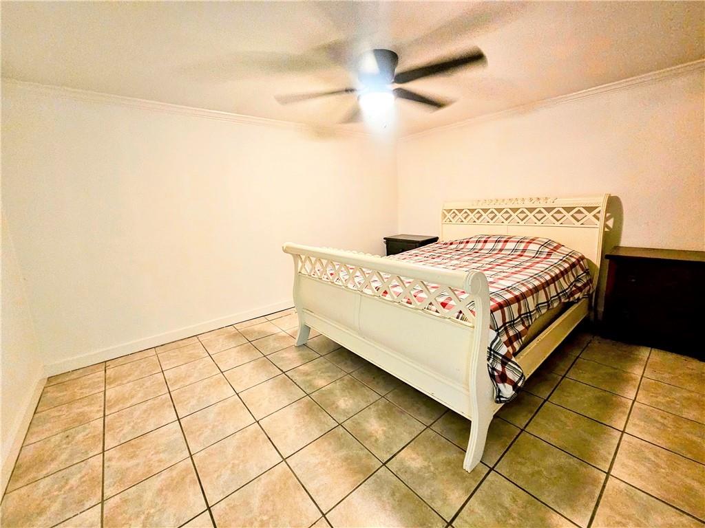 1665 Cunningham Road Southwest Marietta, GA 30008 - Photo 31 of 36 a bed sitting in a bedroom next to a window