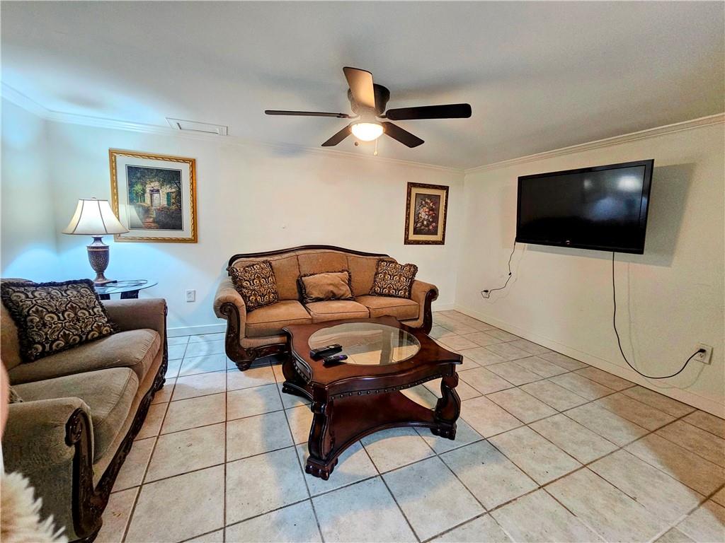 1665 Cunningham Road Southwest Marietta, GA 30008 - Photo 32 of 36 a living room with furniture and a flat screen tv