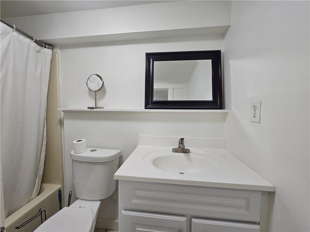 1665 Cunningham Road Southwest Marietta, GA 30008 - Photo 36 of 36 a bathroom with a toilet sink and mirror