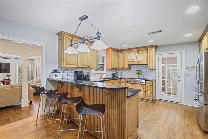 1665 Cunningham Road Southwest Marietta, GA 30008 - Photo 4 of 36 a kitchen with stainless steel appliances granite countertop a kitchen island hardwood floor and a sink
