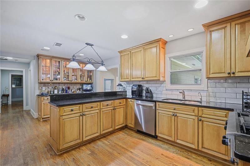1665 Cunningham Road Southwest Marietta, GA 30008 - Photo 6 of 36 a kitchen with a sink cabinets and wooden floor