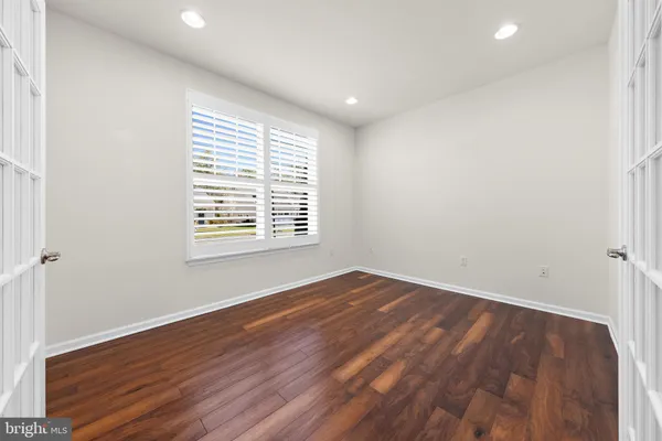 an empty room with windows and closet