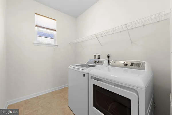 an empty room with wooden floor and a fireplace