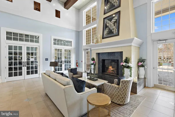 a living room with furniture a fireplace and a large window