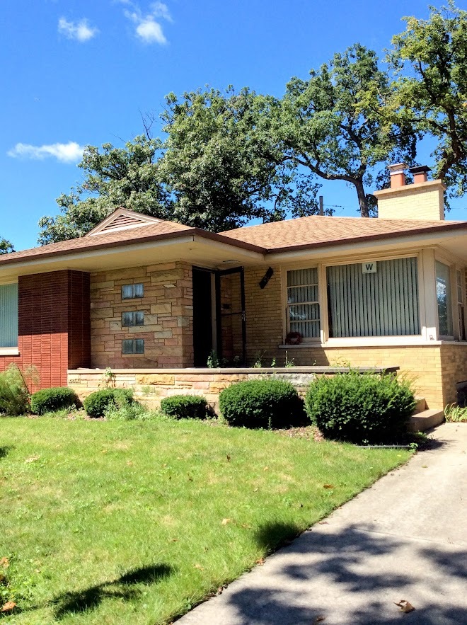 Undisclosed Address North Riverside, IL 60546 - Photo 1 of 12 a front view of a house with garden