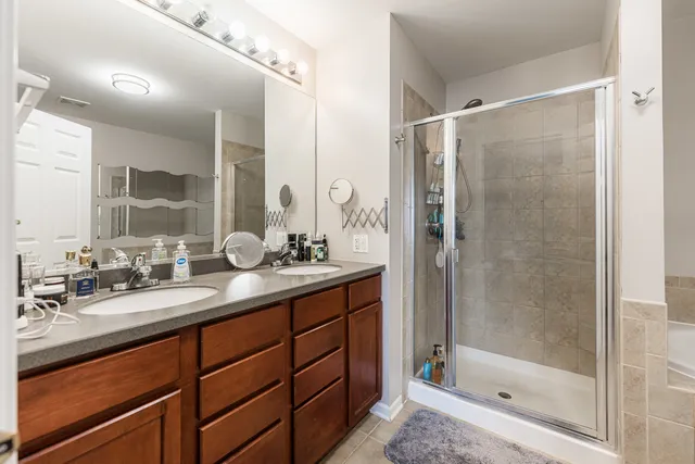 a bathroom with a shower sink and mirror