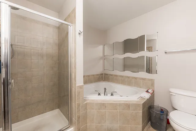 a white bath tub sitting next to a toilet