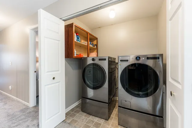 a view of a hallway with washer and dryer