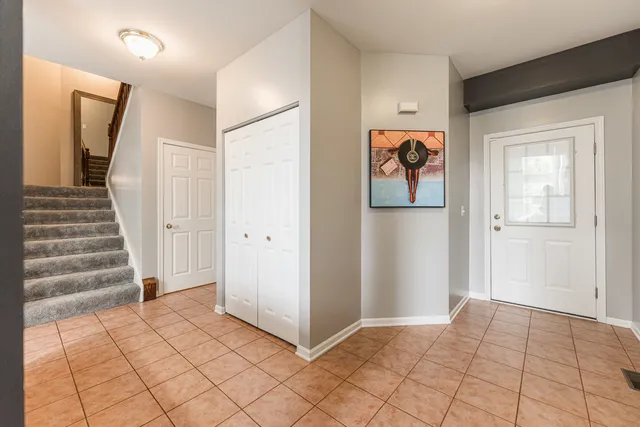 a view of a hallway to rooms and stairs