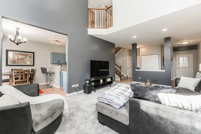 a living room with fireplace furniture and a flat screen tv
