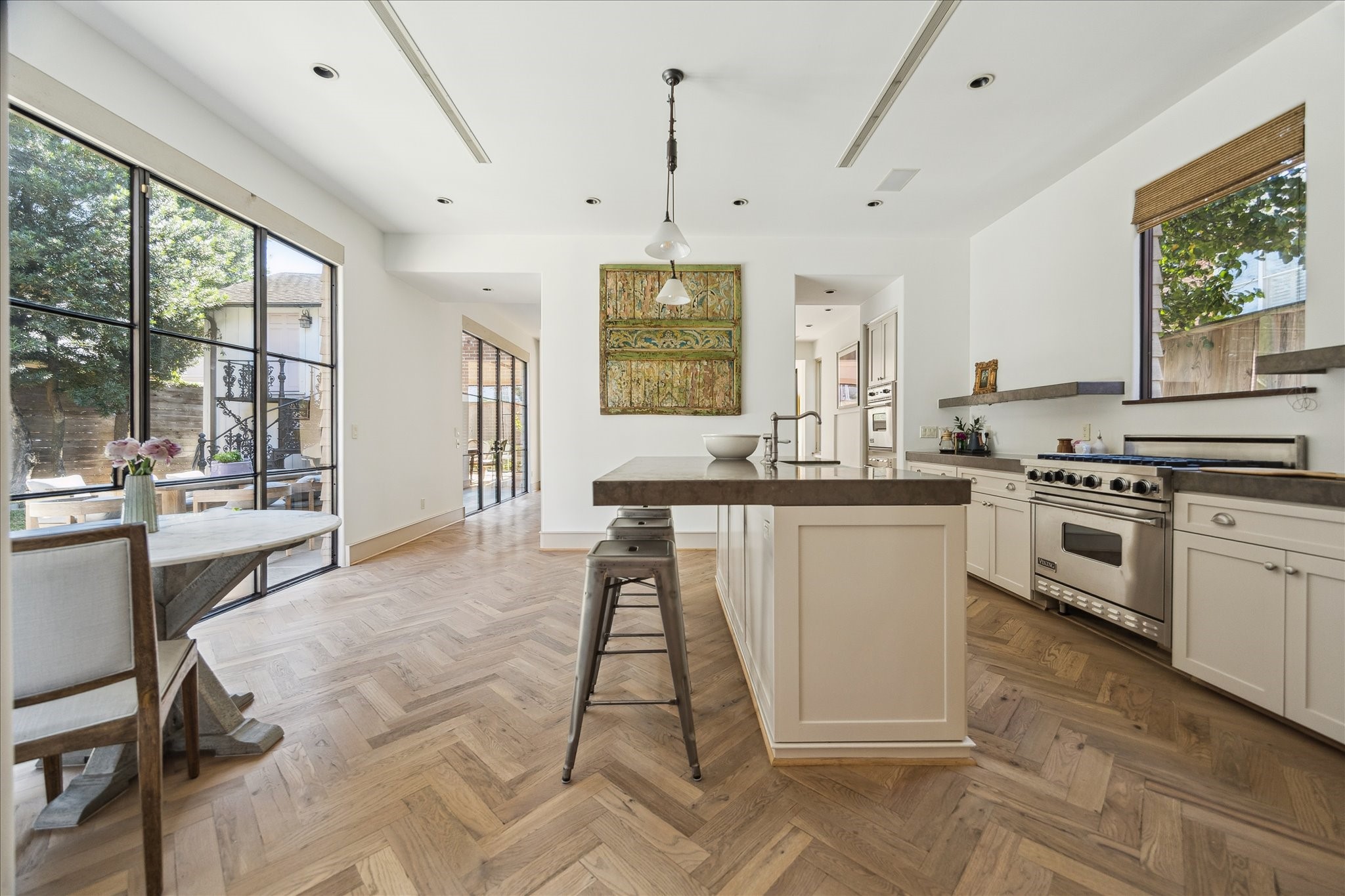 1807 Albans Road Houston, TX 77005 - Photo 13 of 39 a kitchen with kitchen island granite countertop a stove a sink dishwasher and white cabinets with wooden floor