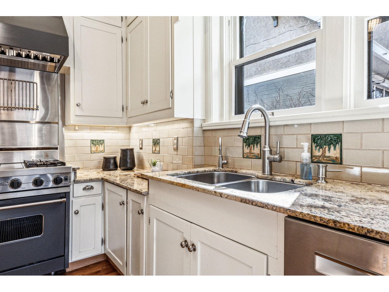 851 14th Street Boulder, CO 80302 - Photo 23 of 50 a kitchen with granite countertop a sink and white cabinets