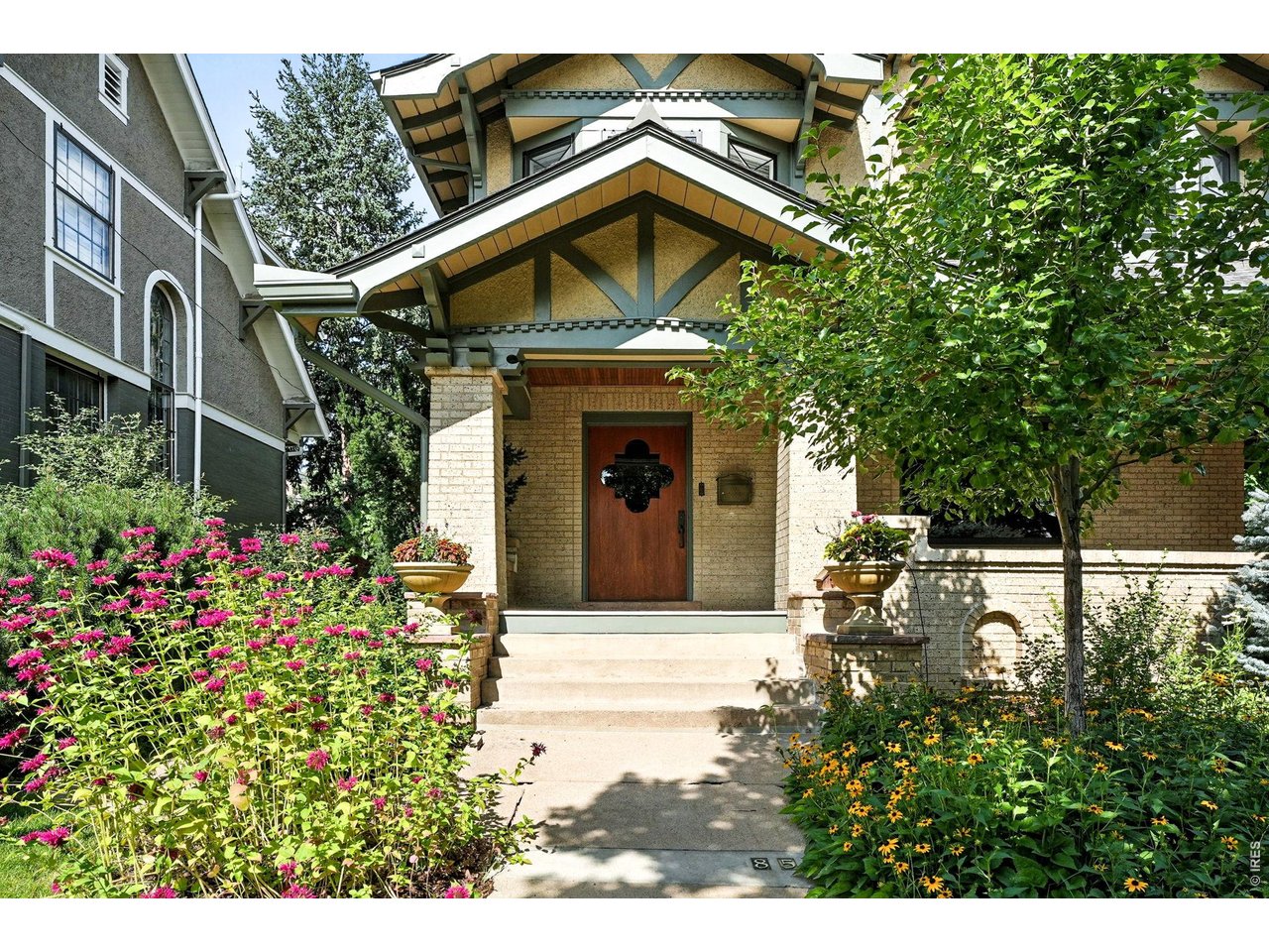 851 14th Street Boulder, CO 80302 - Photo 4 of 50 a front view of a house with a yard and garage