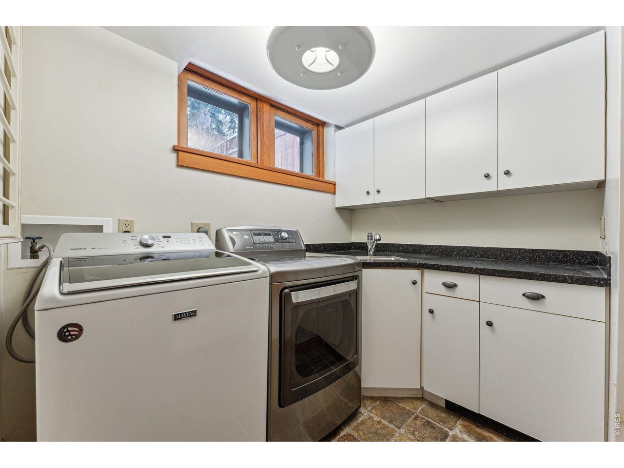 851 14th Street Boulder, CO 80302 - Photo 48 of 50 a utility room with cabinets washer and dryer